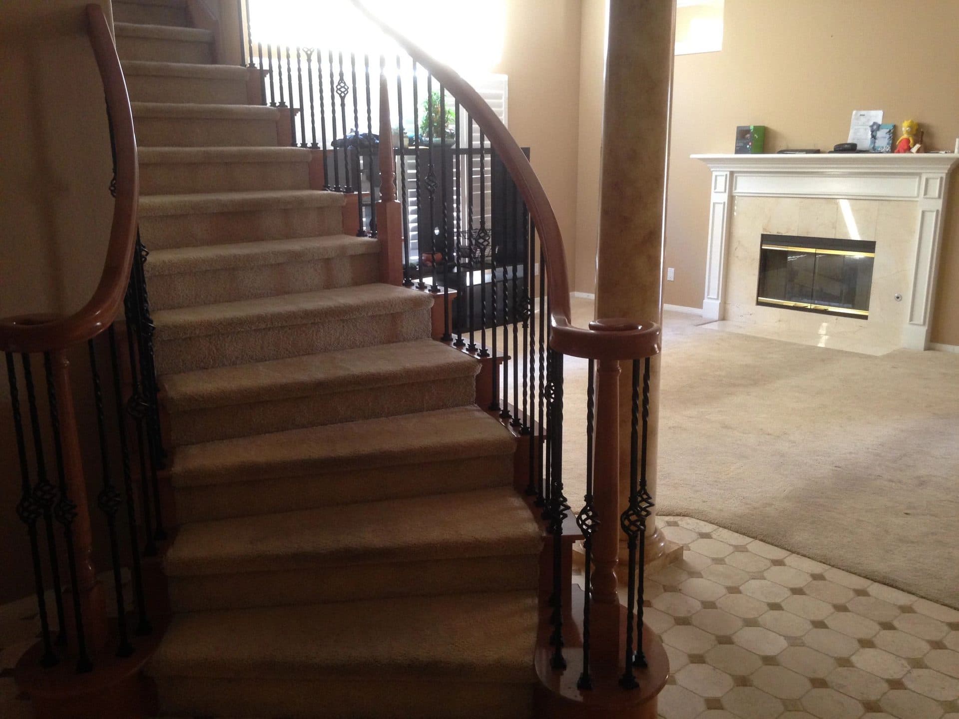Carpeted staircase and living room in a family home