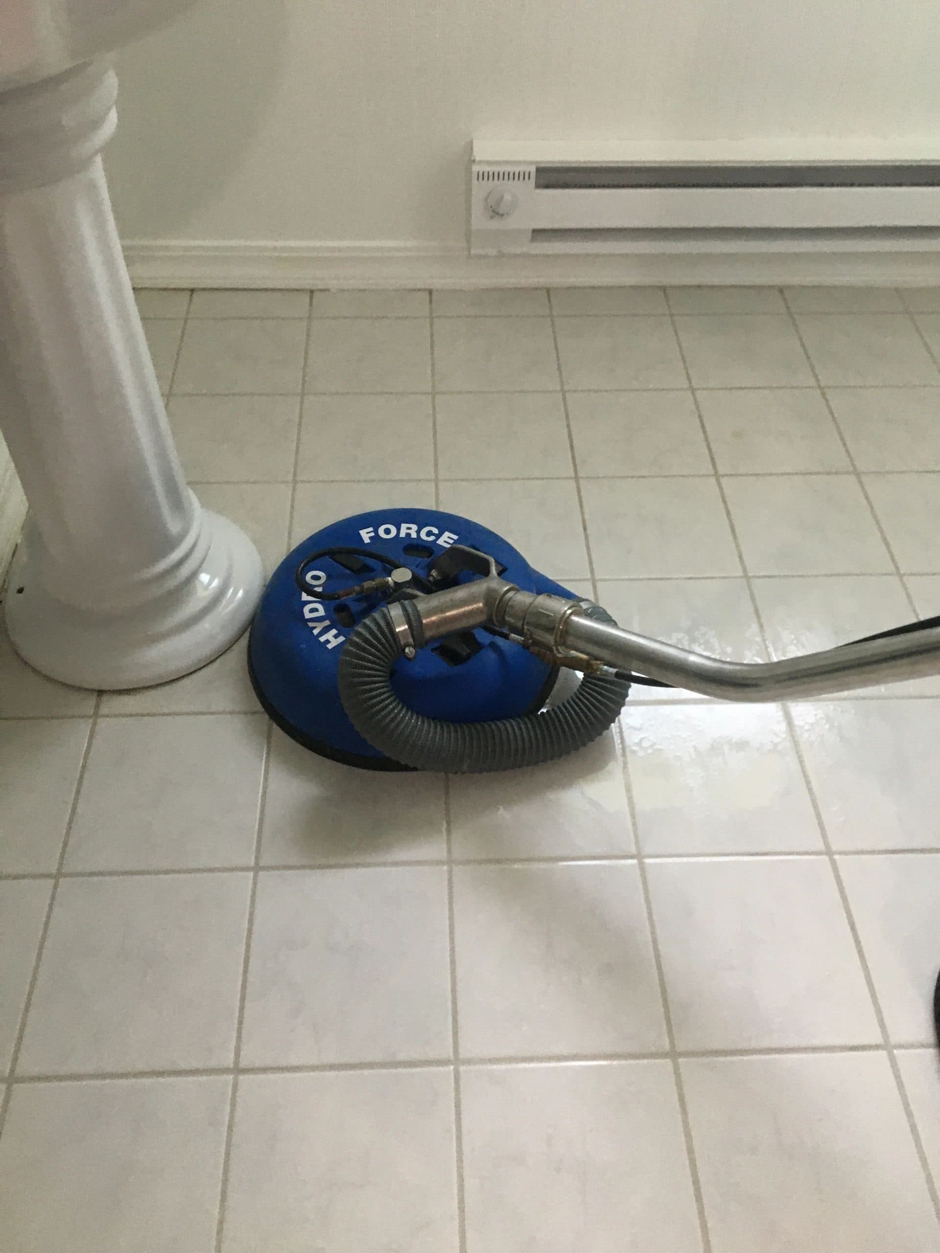 HydroForce spinner tool cleaning white bathroom tile and grout